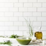 Vegan Chimichurri in a glass bowl with herbs, olive oil, and garlic