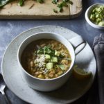 Vegan White Bean Chili in a cup garnished with avocado and hemp seeds